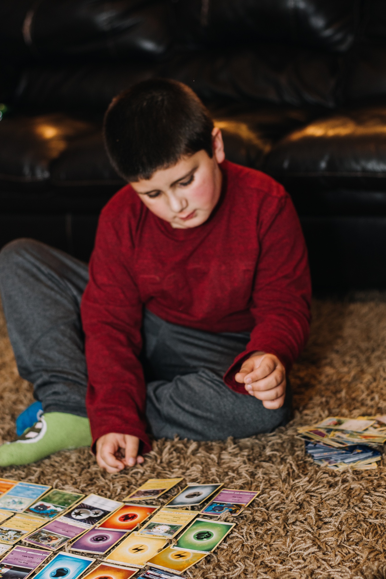 A boy playing Pokémon cards