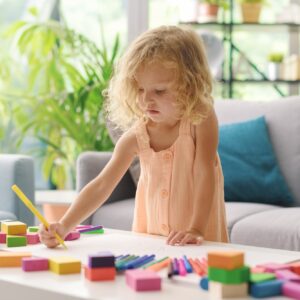 Cute girl coloring with markers