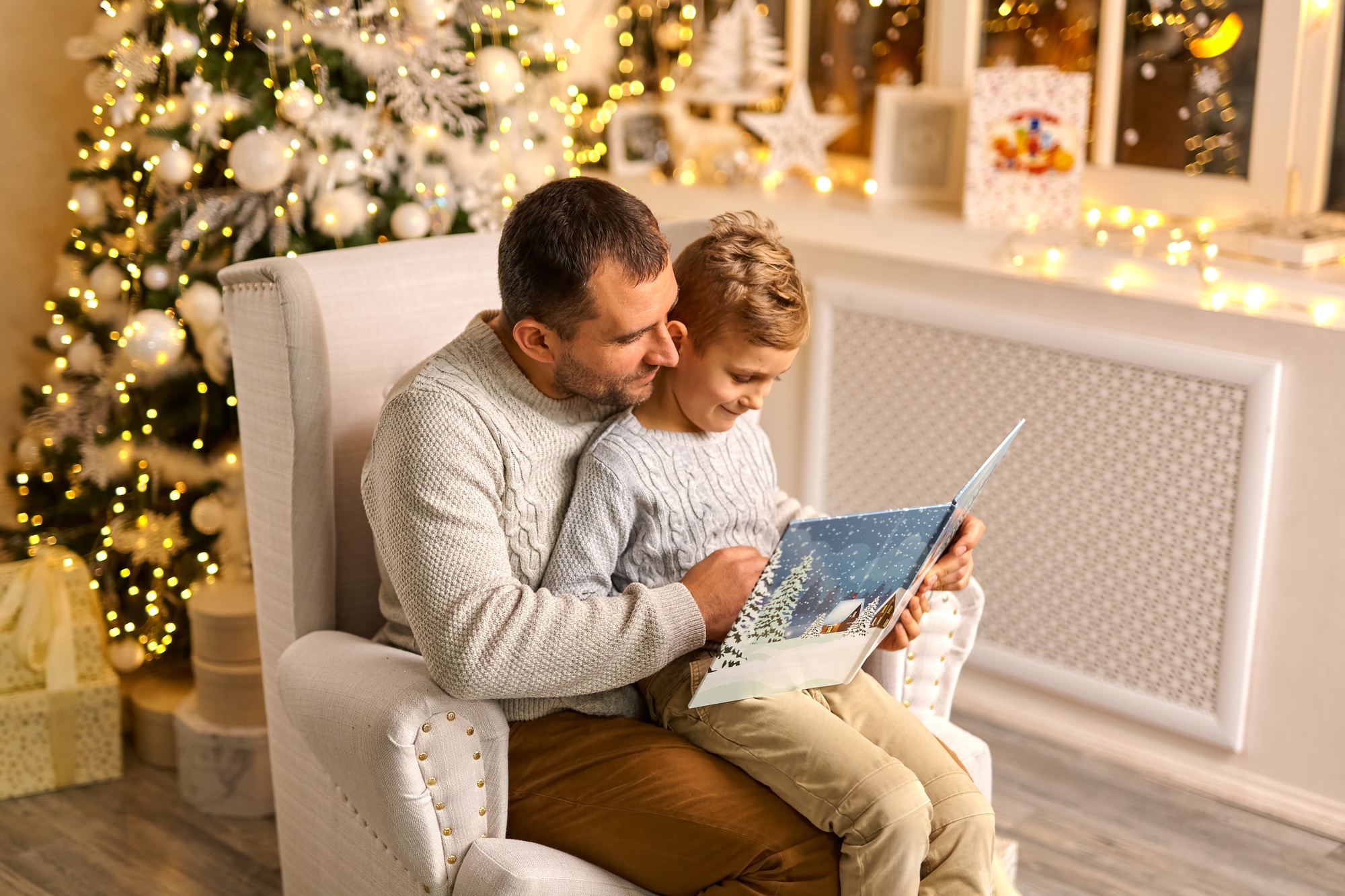 father and son talk enjoy noel eve, reading book