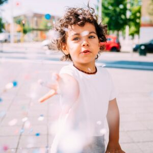 Toddler playing with confetti in park